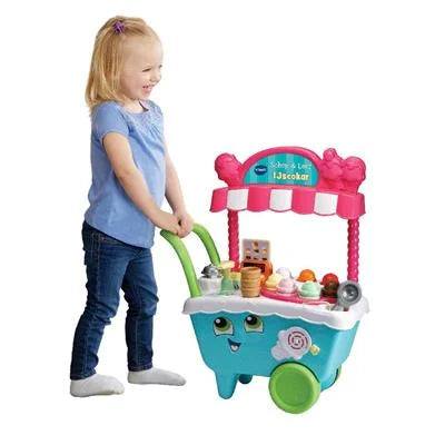 Speelgoed voor baby's: kleurrijke kunststof winkelwagen met roze details, groen handvat en speelaccessoires